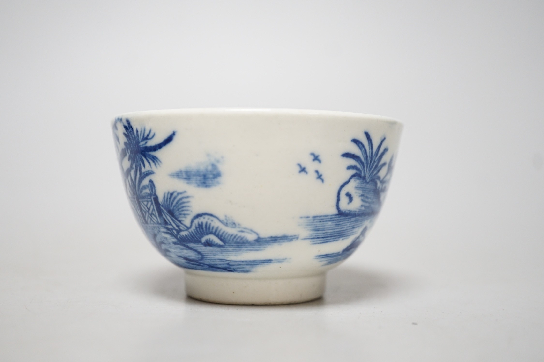 An 18th century Caughley teabowl and saucer printed with the uncommon Fence and House pattern. 6cm tall overall